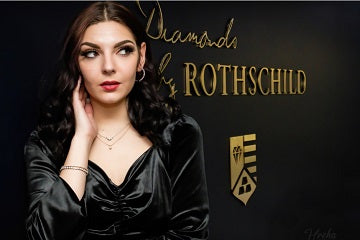 Lady with diamond jewelry in front of Diamonds by Rothschild sign