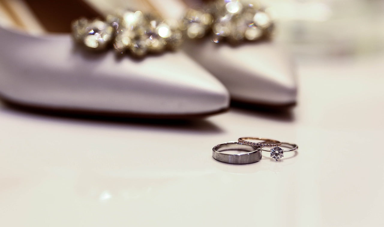 Bridal Ring Set in front of wedding shoes blurred in the background