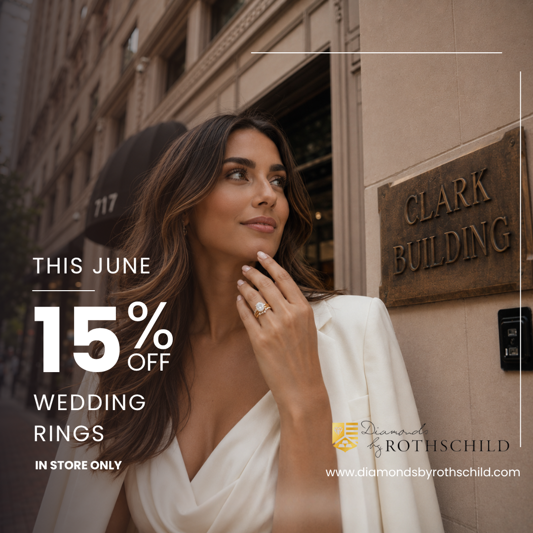 Woman wearing a ring with promotional text for 15% off wedding rings in June, in front of the Clark Building.