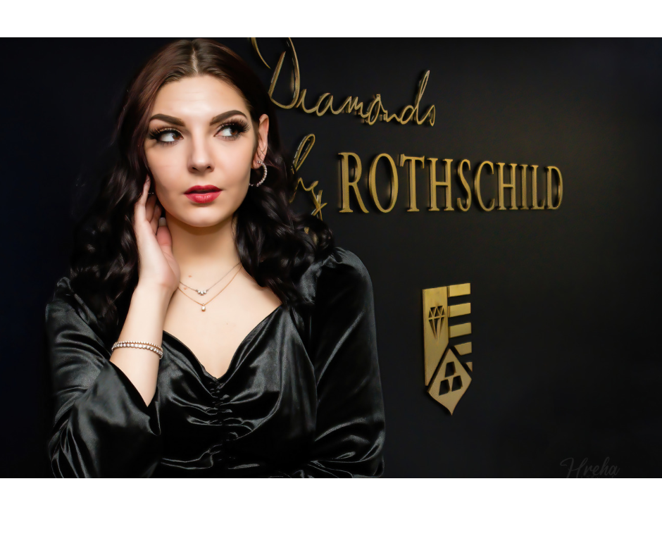Lady with diamond jewelry in front of Diamonds by Rothschild sign