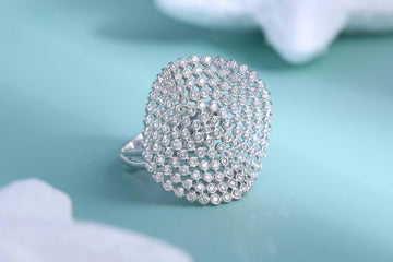 Custom White Gold Fashion Ring Encrusted in Round Cut Diamonds in a Bezel Setting