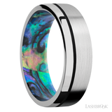7 mm wide/Flat/14K White Gold band with one 0.5 mm Off Center inlay of Black also featuring a Abalone sleeve.