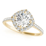Top view of round center cushion halo ring in a cathedral prong setting with a single row pave shank in yellow gold