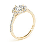 Angle view of round center cushion halo ring in a cathedral prong setting with a single row pave shank in yellow gold