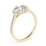 Angle view of round center cushion halo ring in a cathedral prong setting with a single row pave shank in yellow gold