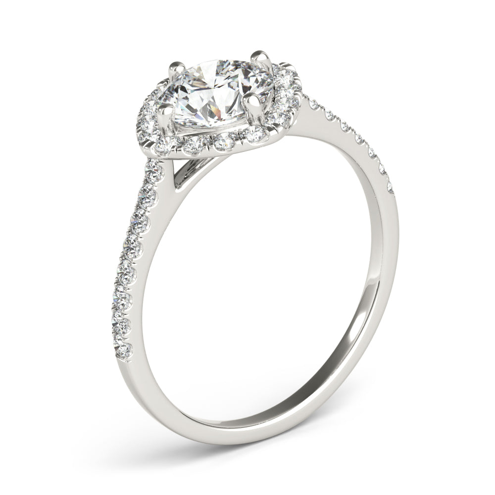 Angle view of round center cushion halo ring in a cathedral prong setting with a single row pave shank in white gold