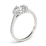 Angle view of round center cushion halo ring in a cathedral prong setting with a single row pave shank in white gold