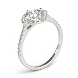 Angle view of round center cushion halo ring in a cathedral prong setting with a single row pave shank in white gold