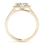 Side view of round center cushion halo ring in a cathedral prong setting with a single row pave shank in yellow gold