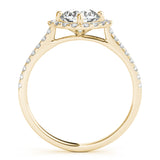 Side view of round center cushion halo ring in a cathedral prong setting with a single row pave shank in yellow gold