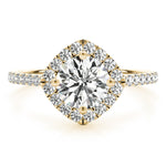 Front view of round center cushion halo ring in a cathedral prong setting with a single row pave shank in yellow gold