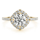 Front view of round center cushion halo ring in a cathedral prong setting with a single row pave shank in yellow gold