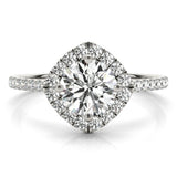 Front view of round center cushion halo ring in a cathedral prong setting with a single row pave shank in white gold