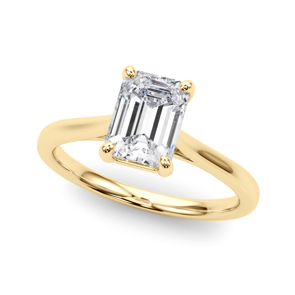 Top view of emerald solitaire ring in cathedral setting in yellow gold