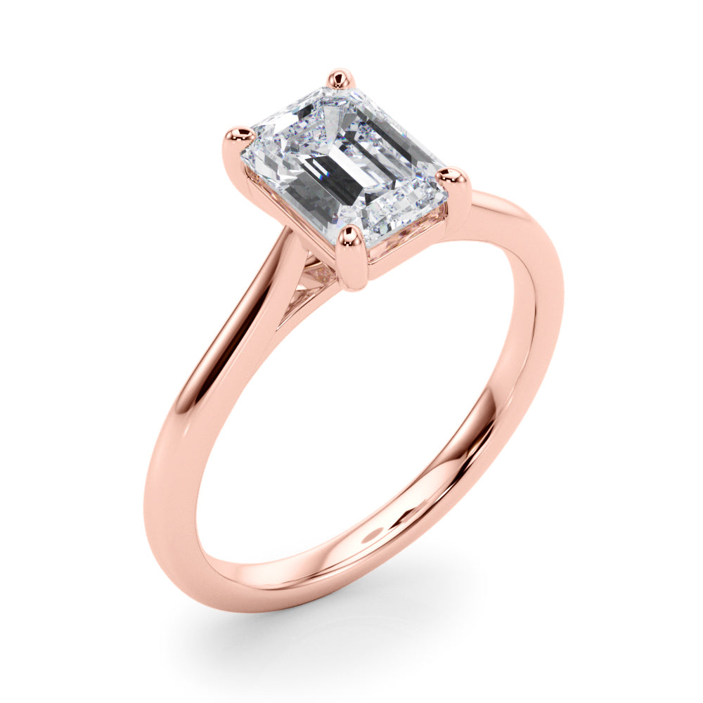 Angle view of emerald solitaire ring in cathedral setting in rose gold
