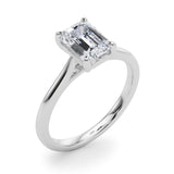Angle view of emerald solitaire ring in cathedral setting in white gold