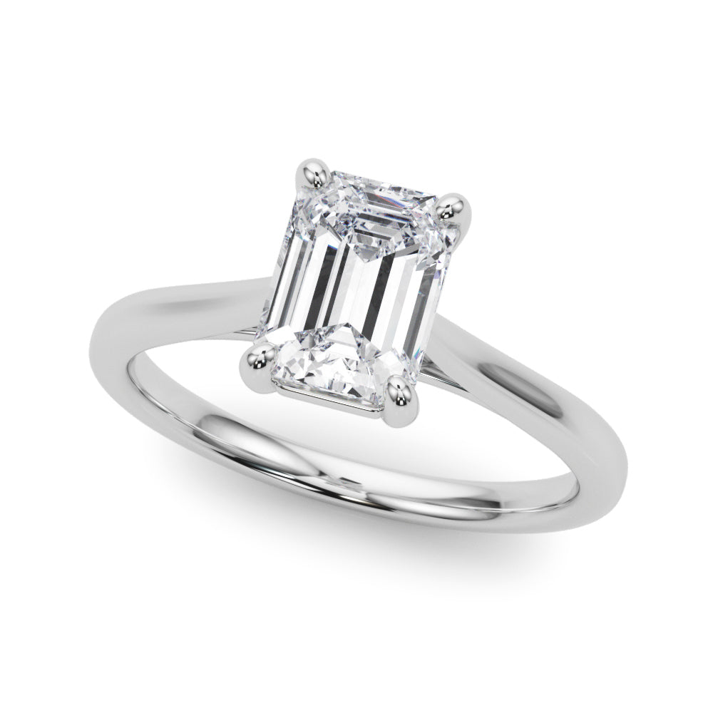 Top view of emerald solitaire ring in cathedral setting in white gold