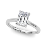 Top view of emerald solitaire ring in cathedral setting in white gold