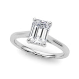 Top view of emerald solitaire ring in cathedral setting in white gold