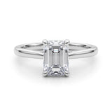 Front view of emerald solitaire ring in cathedral setting in white gold