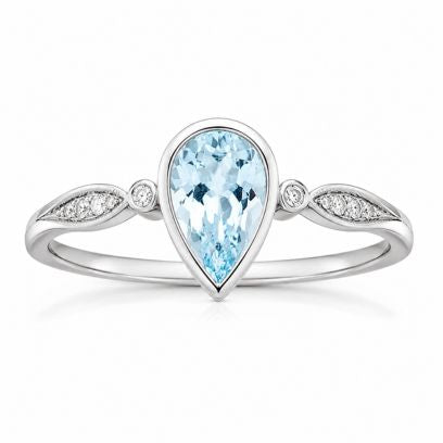Ring with a pear-shaped blue gemstone and diamond accents on a white background