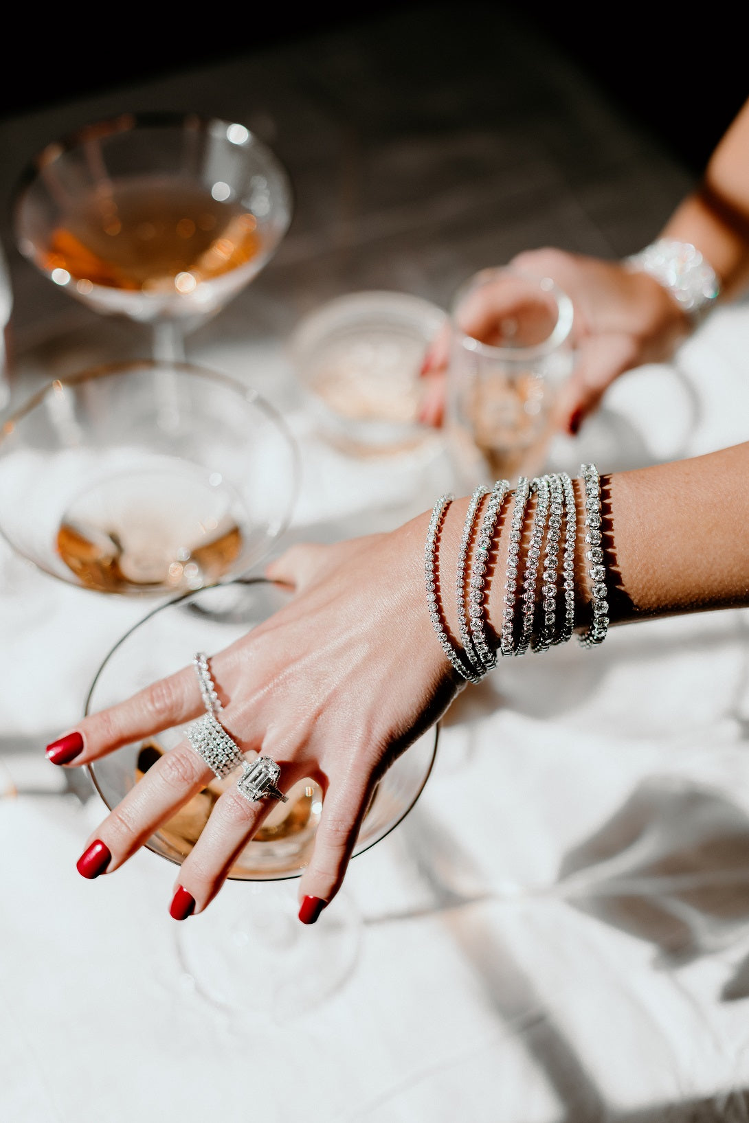 Lady hand with diamond rings and diamond tennis bracelets