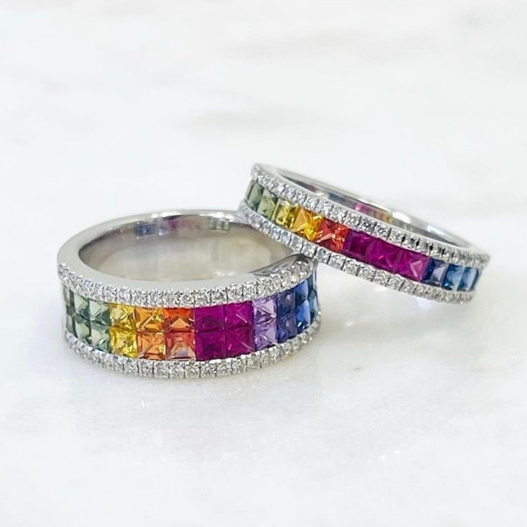 Two silver rings with colorful gemstones on a white background