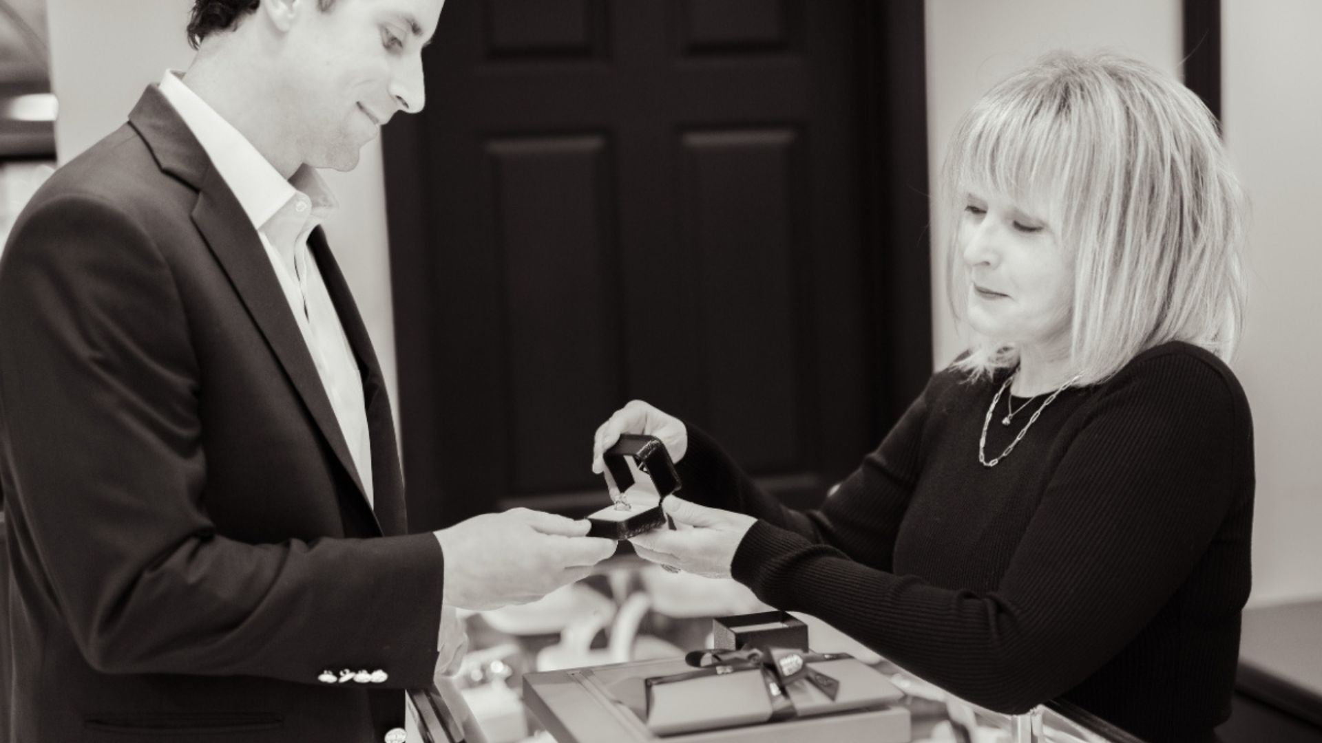 Man and woman looking at jewelry in a store