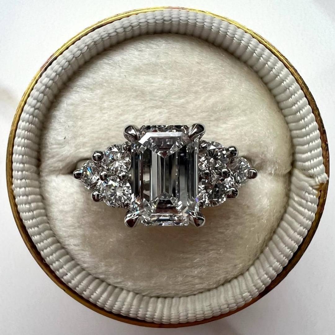Diamond ring in a round, beige velvet box on a white background
