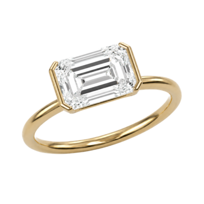 Gold ring with an east west emerald-cut diamond in a half bezel setting on a white background