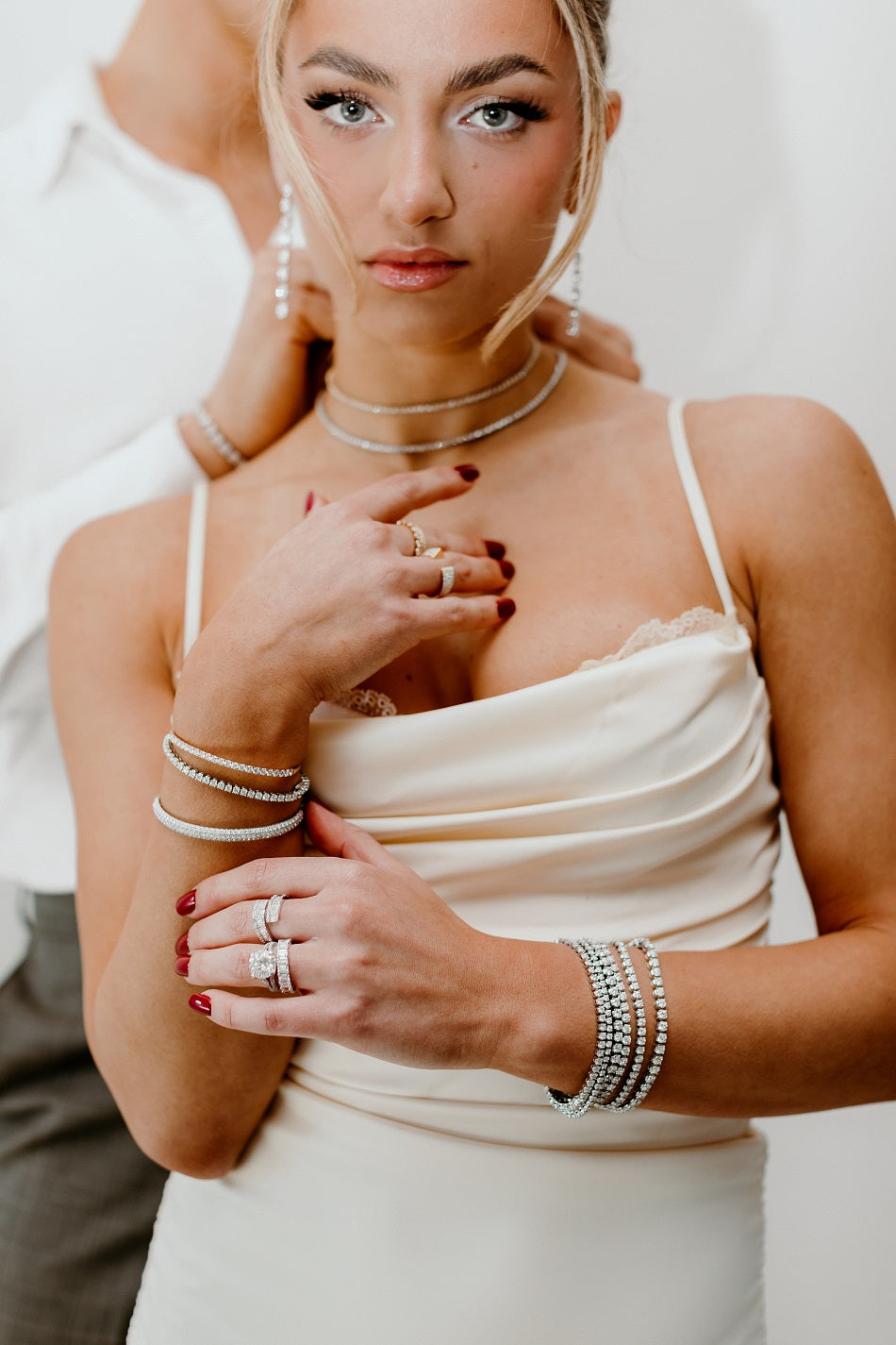 Lady adorned with tennis bracelets, diamond necklaces and diamond earrings for Christmas 2024