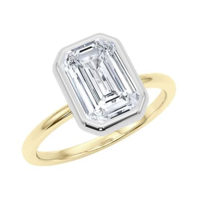 Whit and yellow gold ring with a large emerald-cut diamond on a white background