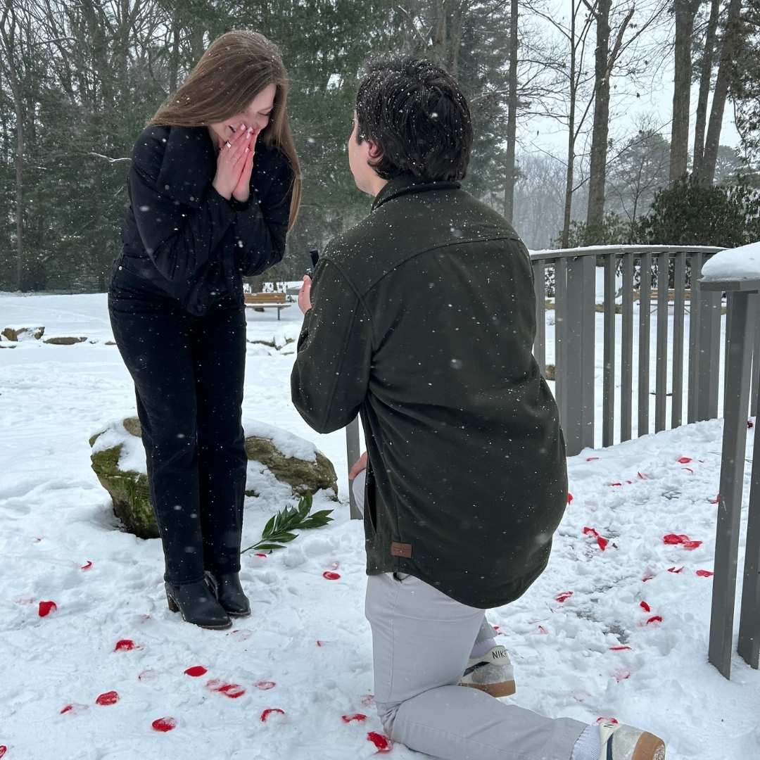 Man proposing to a woman while snow is falling