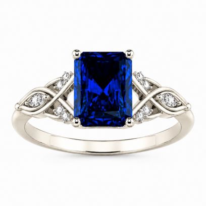 Engagement ring with a blue sapphire and diamond accents on a white background