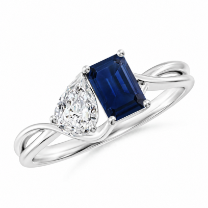 Elegant Toi et Moi engagement ring with a blue emerald cut gemstone and pear shape diamond on a white background