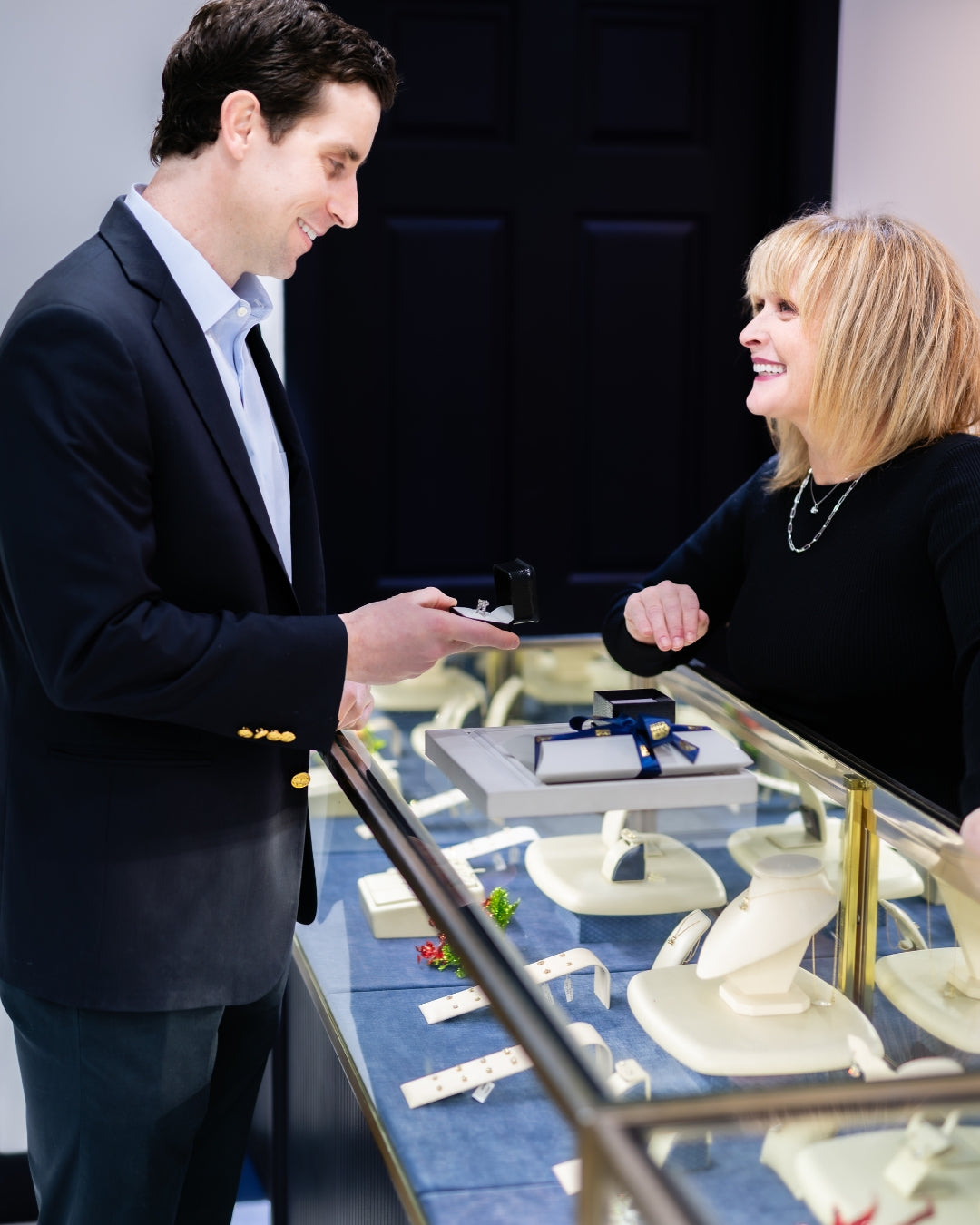 Store manager talking to a client about their custom design engagement ring