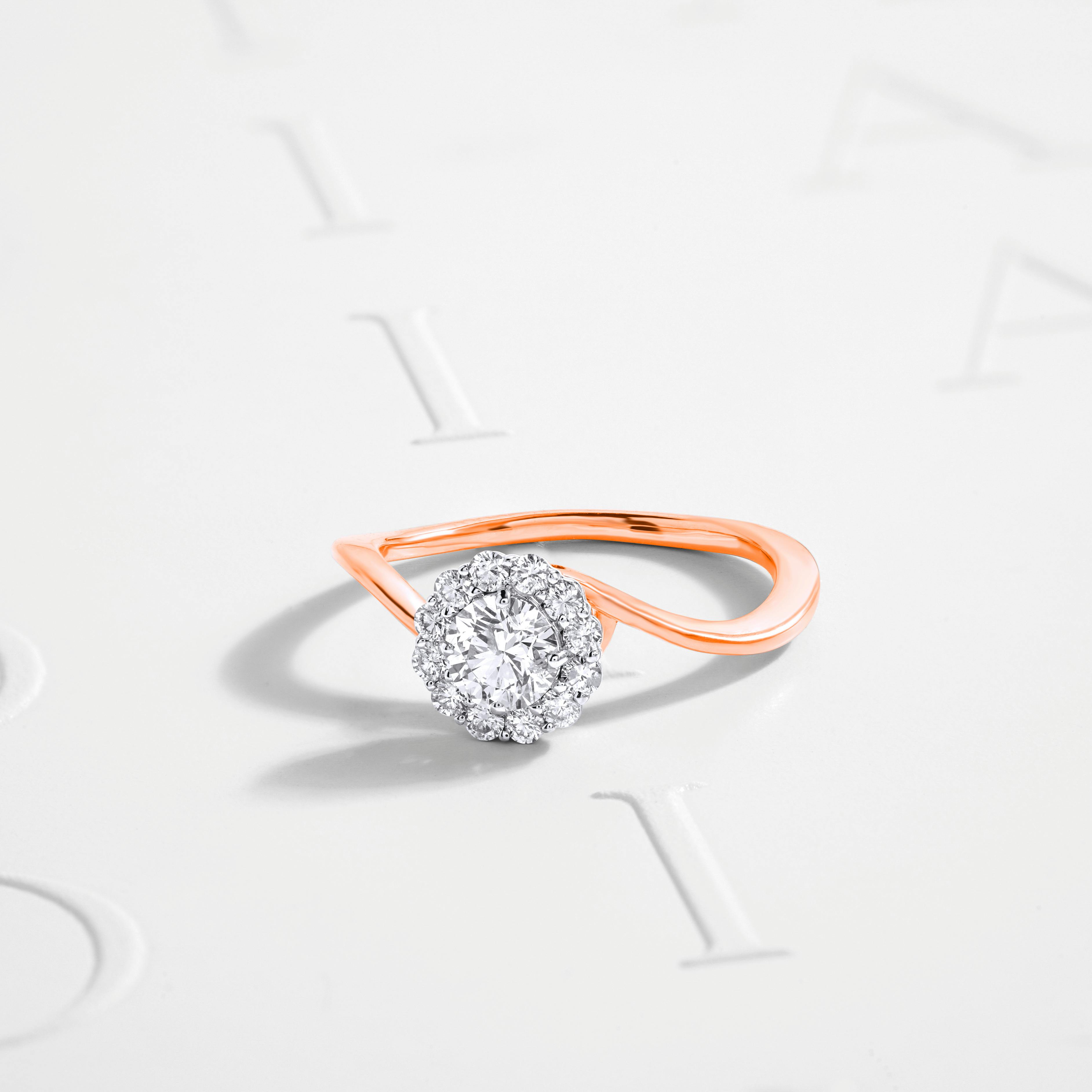 A ring setting securing the diamond in a halo setting with rose gold metal